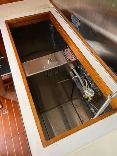 Taco Truck Yacht Photos Pics Open compartment on 1996 Prout 45 boat, showing metal tank and piping.