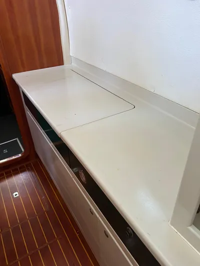 Taco Truck Yacht Photos Pics Interior of 1996 Prout 45 yacht with wooden flooring and white countertop.