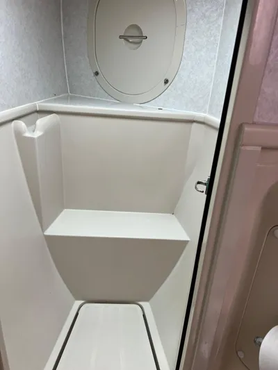 Taco Truck Yacht Photos Pics Interior of a 1996 Prout 45 boat shower area with white fixtures.