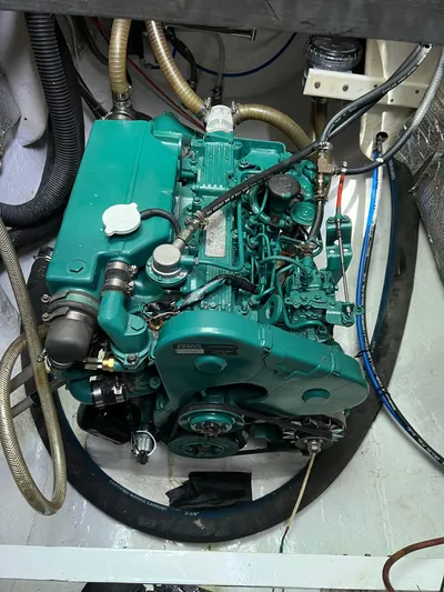 Taco Truck Yacht Photos Pics Engine of a 1996 Prout 45 boat, featuring green components and various hoses.