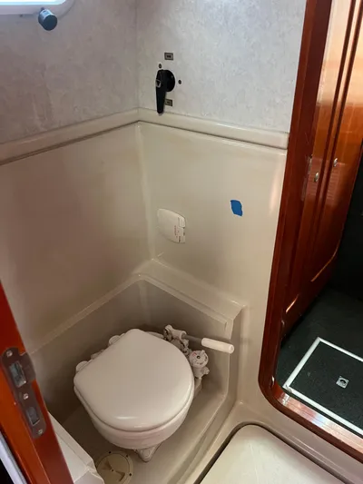 Taco Truck Yacht Photos Pics 1996 Prout 45 yacht bathroom with compact marine toilet and wooden door.