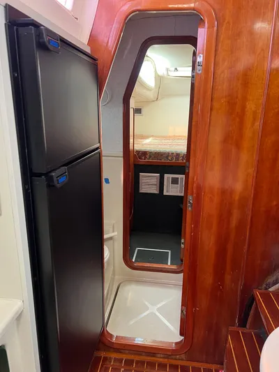 Taco Truck Yacht Photos Pics Interior of 1996 Prout 45 yacht with wooden paneling and compact kitchen area.