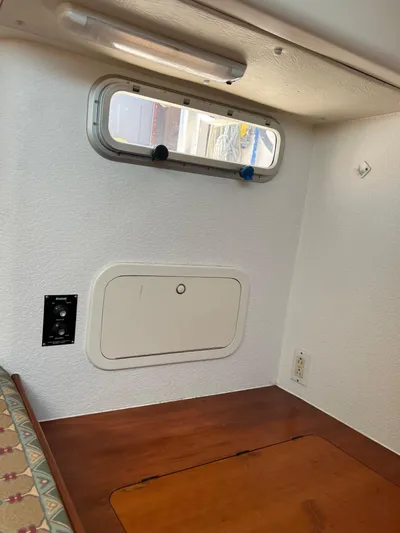 Taco Truck Yacht Photos Pics Interior cabin of a 1996 Prout 45 boat, featuring a small window and wooden surface.