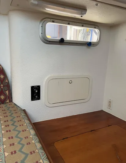 Taco Truck Yacht Photos Pics Interior of a 1996 Prout 45 boat, featuring a small window and wooden surfaces.