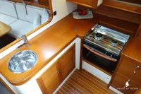 Luxurious yacht kitchen with wooden cabinetry, stainless steel sink, and modern stove. Von Ahlen 403, 2014.