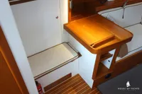 Interior of 2014 Von Ahlen 403 yacht with wooden table and seating area.