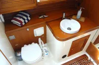 Luxurious yacht bathroom with wooden accents, featuring a sink and marine toilet, Von Ahlen 403, 2014.