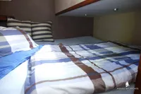 Cozy cabin bed with striped bedding in 2014 Von Ahlen 403 yacht interior.
