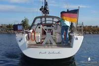Sailing yacht Von Ahlen 403, 2014 model, with German flag on open water.