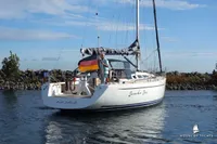 Sailing yacht Von Ahlen 403, 2014 model, on calm waters with German flag.