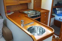 Luxurious yacht kitchen interior with wooden cabinetry, sink, and stove, Von Ahlen 403, 2014 model.