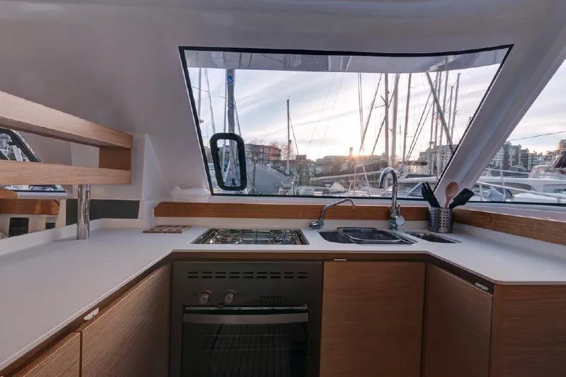 Escape Yacht Photos Pics Modern kitchen area in a 2016 Nautitech 40 Open catamaran with marina view.