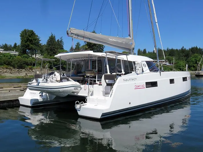 Escape Yacht Photos Pics 2016 Nautitech 40 Open catamaran docked in a serene marina.