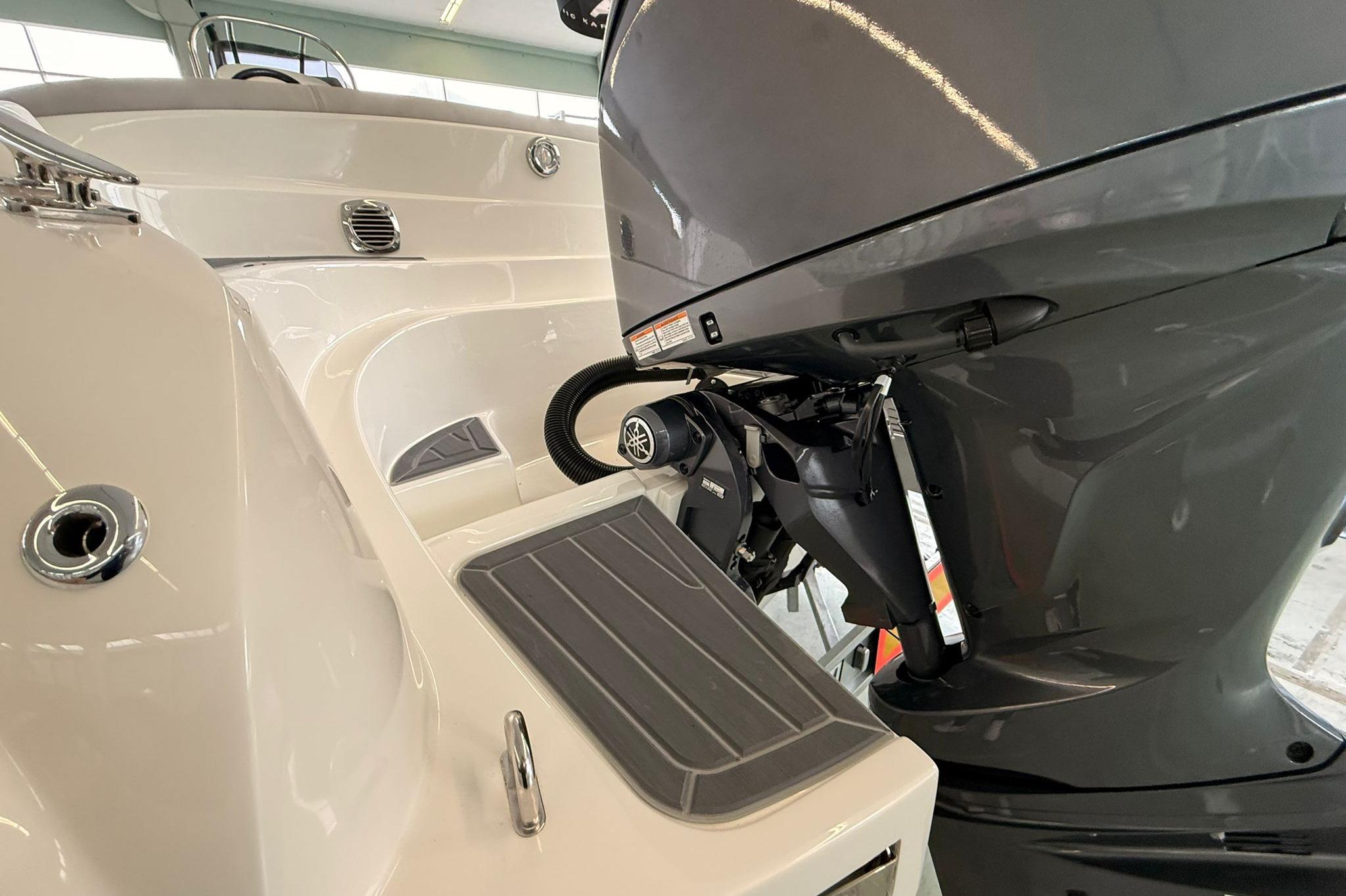 Boat engine and deck detail, featuring a modern outboard motor and sleek design.