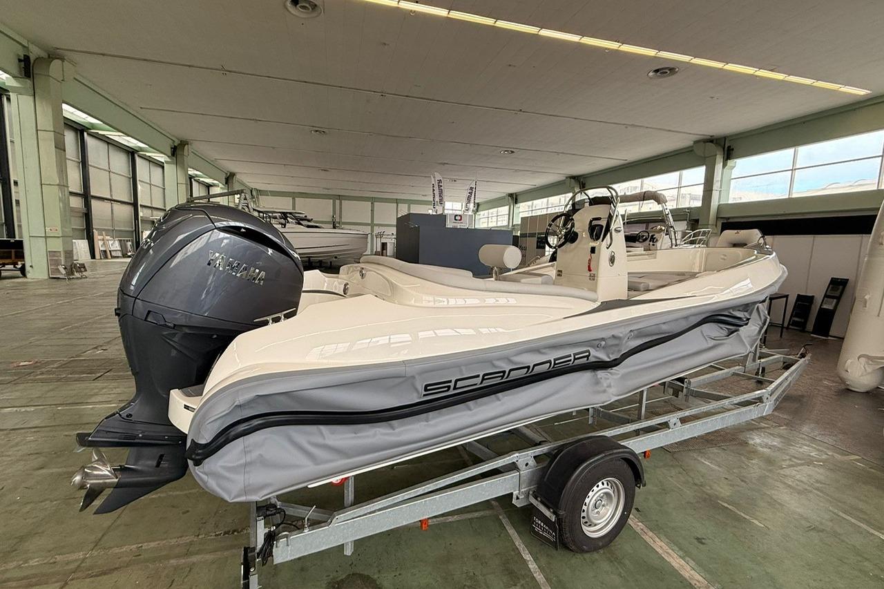 RIB boat on trailer in warehouse, featuring Yamaha engine, Scanner ENVY 630 model, 2025.