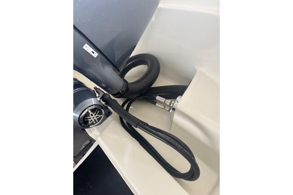 Close-up of Scanner ENVY 630 boat engine components, featuring hoses and connectors, 2025 model.