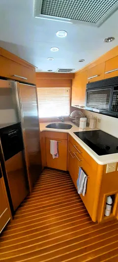  Yacht Photos Pics Interior of 2000 Hatteras 60 Convertible yacht kitchen with modern appliances and wood flooring.