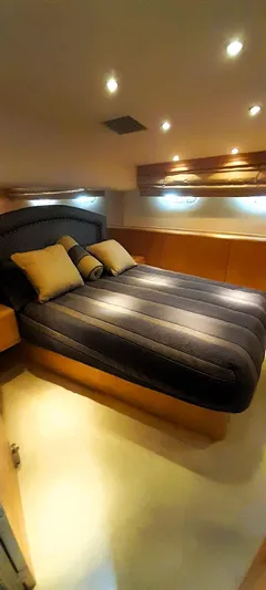  Yacht Photos Pics Luxurious bedroom interior of 2000 Hatteras 60 Convertible yacht with modern lighting.