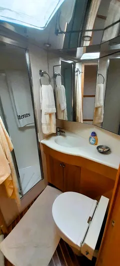  Yacht Photos Pics Bathroom interior of 2000 Hatteras 60 Convertible yacht, featuring modern amenities and sleek design.