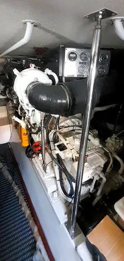  Yacht Photos Pics Engine room of 2000 Hatteras 60 Convertible yacht, showcasing mechanical components and gauges.