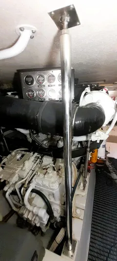  Yacht Photos Pics Engine room of 2000 Hatteras 60 Convertible yacht, showcasing machinery and gauges.