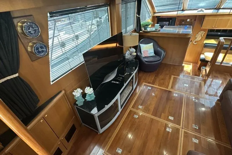 On Your Mark Yacht Photos Pics Luxurious 2005 Jefferson Motoryacht interior with polished wood floors and modern furnishings.