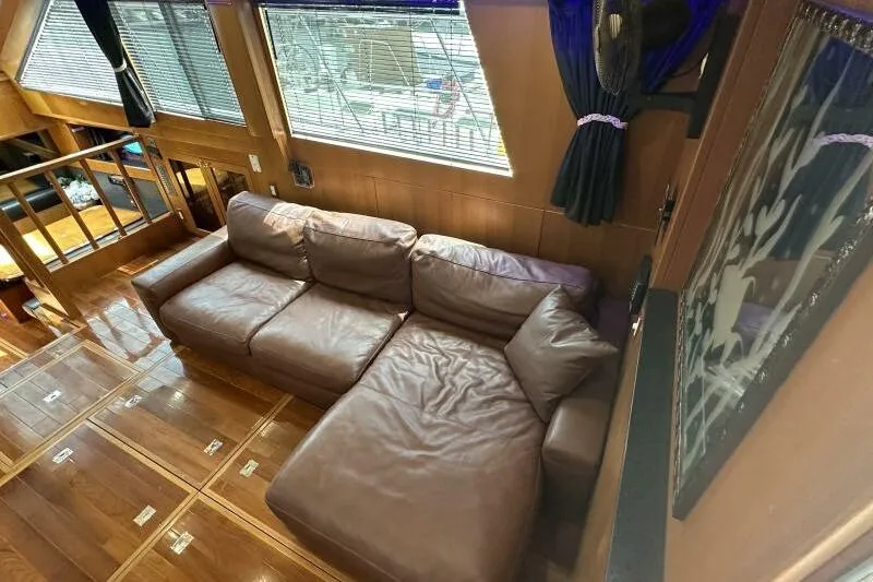 On Your Mark Yacht Photos Pics Luxurious interior of 2005 Jefferson Motoryacht with leather sofa and wooden flooring.