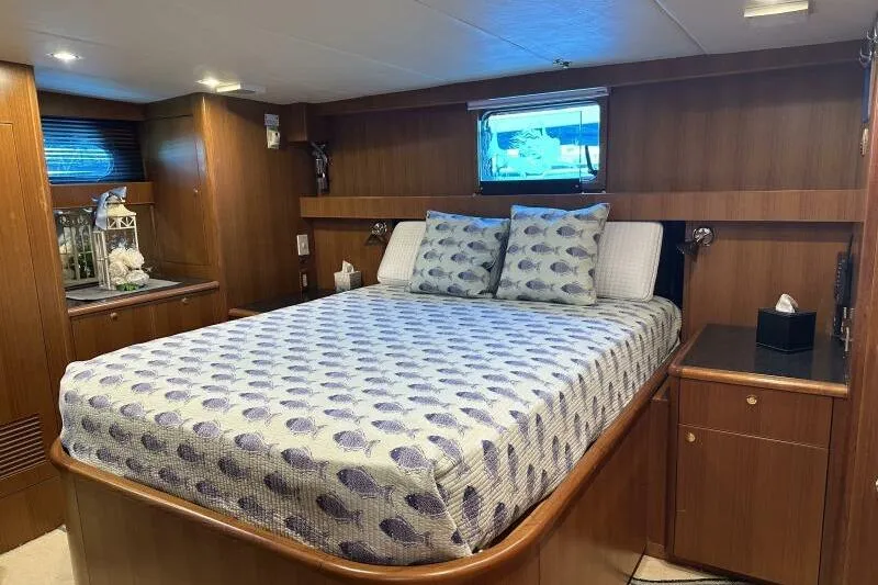 On Your Mark Yacht Photos Pics Luxurious 2005 Jefferson Motoryacht bedroom with elegant wood paneling and cozy bedding.