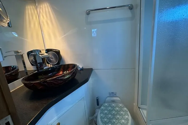 On Your Mark Yacht Photos Pics Luxurious bathroom in 2005 Jefferson Motoryacht with elegant vessel sink and modern fixtures.