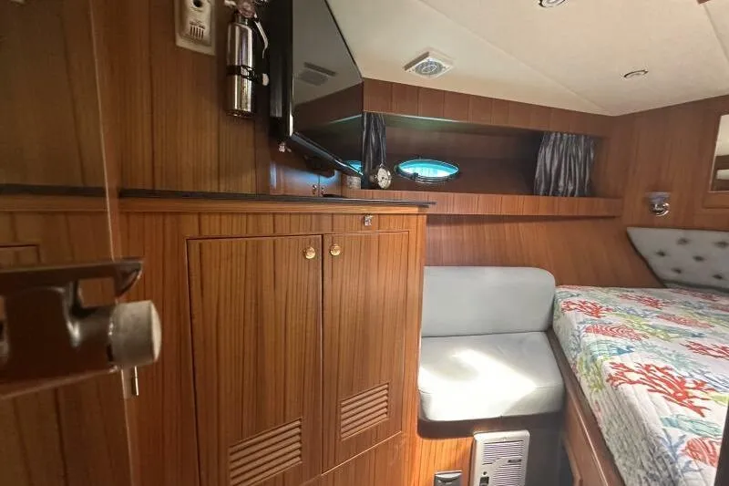 On Your Mark Yacht Photos Pics Luxurious 2005 Jefferson Motoryacht cabin with wood paneling and cozy bed.