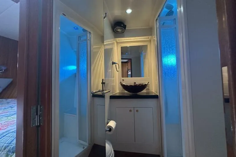 On Your Mark Yacht Photos Pics Luxurious bathroom in a 2005 Jefferson Motoryacht with modern fixtures and ambient lighting.