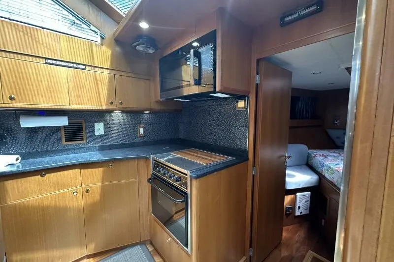 On Your Mark Yacht Photos Pics Luxurious 2005 Jefferson Motoryacht kitchen with modern appliances and cozy cabin view.