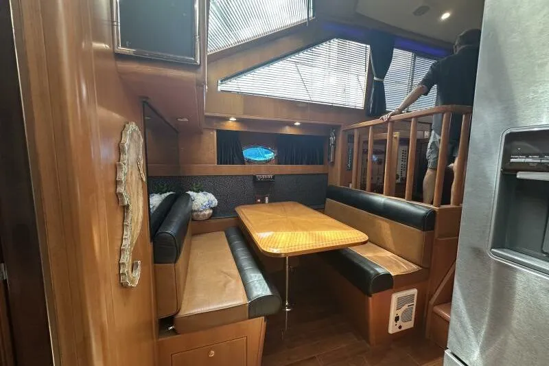 On Your Mark Yacht Photos Pics Luxurious interior of a 2005 Jefferson Motoryacht with elegant wood finishes and seating area.