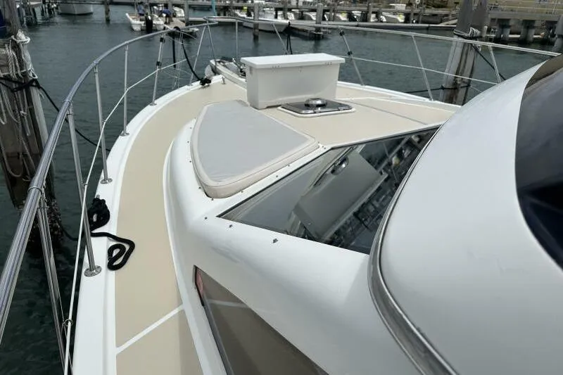 On Your Mark Yacht Photos Pics 2005 Jefferson Motoryacht deck view at marina, showcasing sleek design and railing.