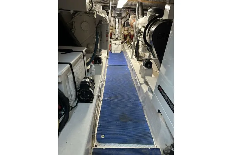 On Your Mark Yacht Photos Pics Engine room of a 2005 Jefferson Motoryacht with blue flooring and machinery.