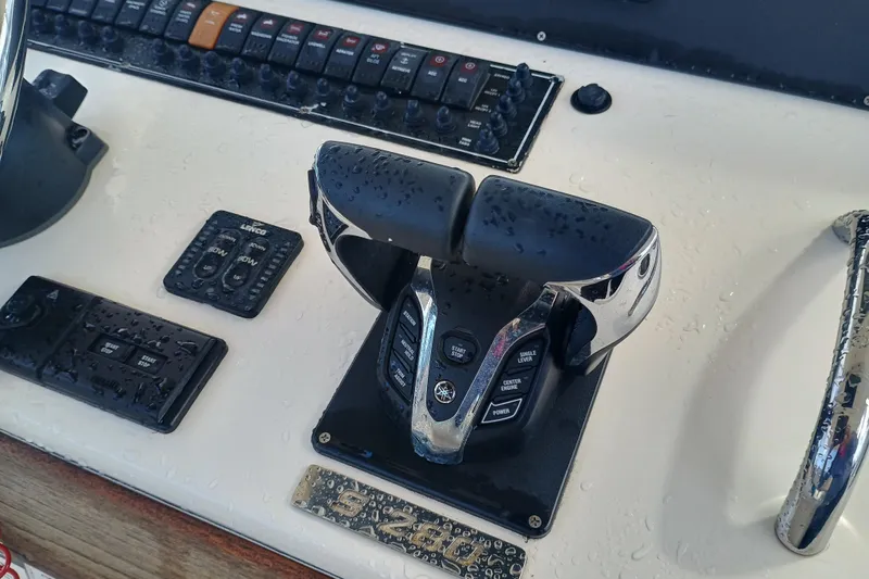 S28-117 Brokerage Joe Yacht Photos Pics Control panel of 2010 Pursuit S 280 Sport boat with throttle and switches.