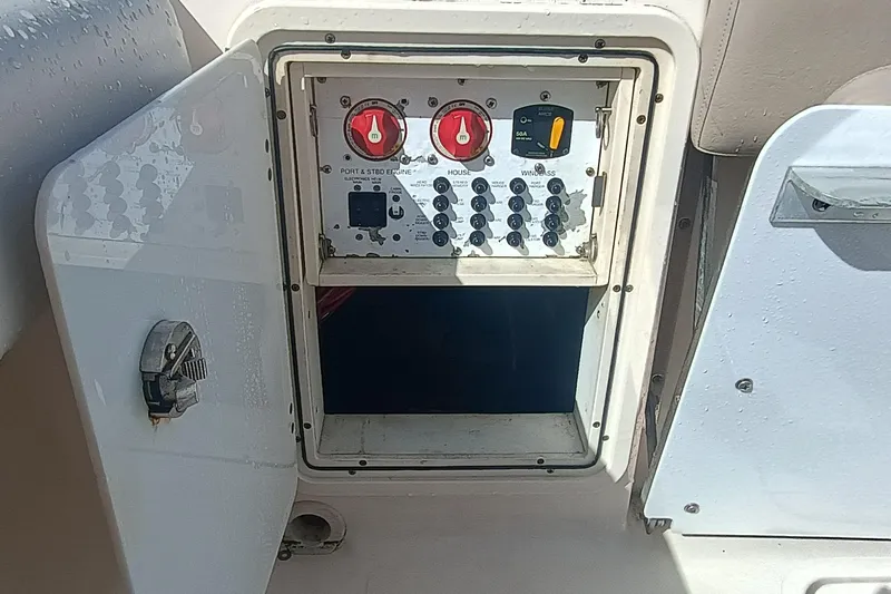 S28-117 Brokerage Joe Yacht Photos Pics Control panel of a 2010 Pursuit S 280 Sport boat with open access door.