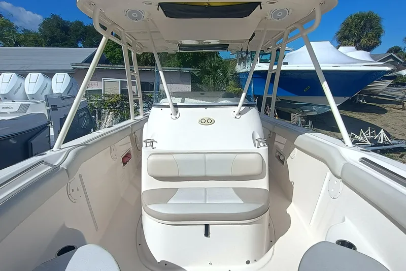 S28-117 Brokerage Joe Yacht Photos Pics 2010 Pursuit S 280 Sport boat interior with seating, under a clear blue sky.