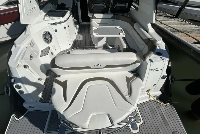  Yacht Photos Pics 2015 Monterey 355 Sport Yacht interior with seating and table, docked at marina.