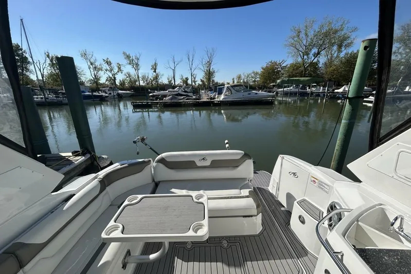  Yacht Photos Pics 2015 Monterey 355 Sport Yacht interior with seating and table, docked in a serene marina.