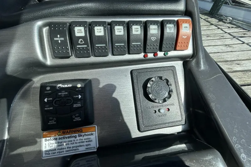  Yacht Photos Pics Control panel of a 2015 Monterey 355 Sport Yacht with various switches and warning label.