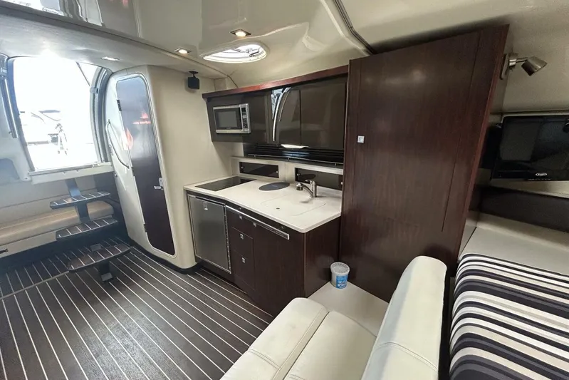  Yacht Photos Pics Interior of 2015 Monterey 355 Sport Yacht with kitchenette and seating area.