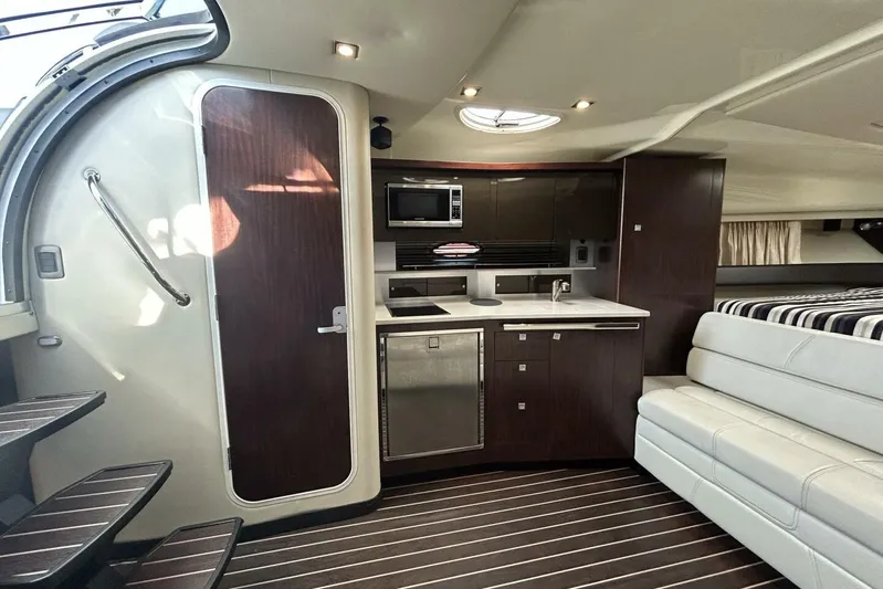  Yacht Photos Pics Luxurious interior of 2015 Monterey 355 Sport Yacht with modern kitchen and seating area.