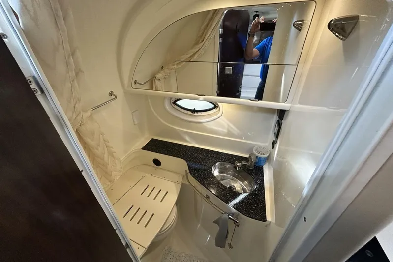  Yacht Photos Pics 2015 Monterey 355 Sport Yacht bathroom with sink, mirror, and porthole window.