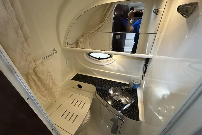  Yacht Photos Pics 2015 Monterey 355 Sport Yacht bathroom with sink, mirror, and porthole window.