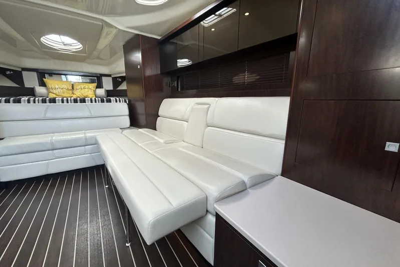  Yacht Photos Pics Luxurious interior of 2015 Monterey 355 Sport Yacht with white leather seating and dark wood accents.