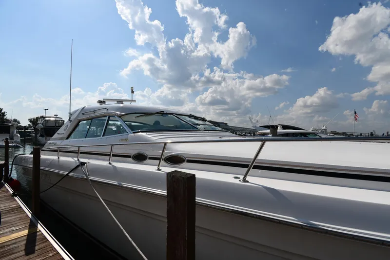  Yacht Photos Pics 1995 Sea Ray 630 Sundancer yacht docked under a partly cloudy sky.