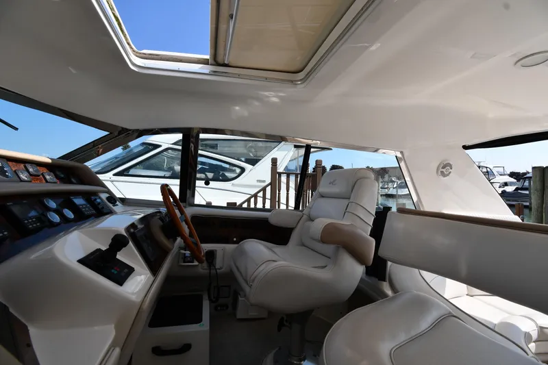  Yacht Photos Pics Interior of 1995 Sea Ray 630 Sundancer yacht with luxurious seating and control panel.