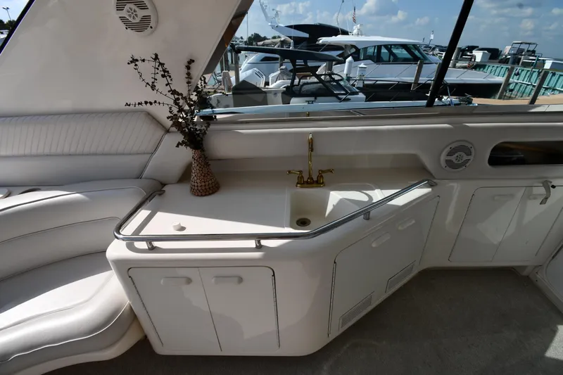  Yacht Photos Pics Luxurious interior of 1995 Sea Ray 630 Sundancer yacht with elegant seating and sink area.