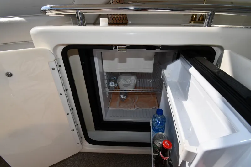  Yacht Photos Pics Mini fridge on 1995 Sea Ray 630 Sundancer yacht, stocked with drinks and snacks.